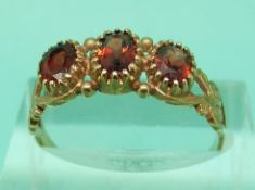 Two 9ct gold rings set with garnets,