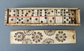 A Napoleonic prisoner of war carved bone domino set in case with sliding lid,