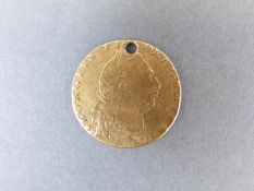 A 1798 gold spade guinea with small hole drilled for mount