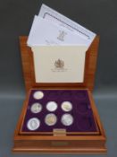 A deluxe wooden collector's casket containing seven of the Golden Jubilee collection silver proof