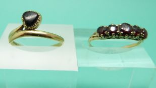 A 9ct gold ring set with garnets and a 9ct gold ring set with onyx