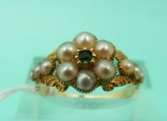 A Victorian mourning ring set with an emerald surrounded by seed pearls (Size O)