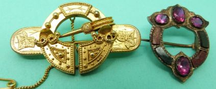 A Victorian yellow metal brooch in the form of a kilt pin/ buckle and another Victorian brooch set