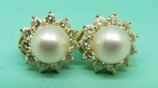 Mikimoto pair of 18ct gold earrings each set with a cultured pearl bordered by 11 round brilliant