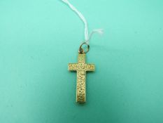 A yellow metal cross with chased foliate decoration
