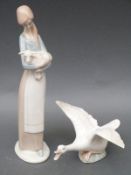 Two Lladro figures of a girl and a goose