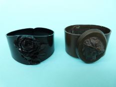 Two bangles, possibly volcanite, one carved with a cameo and one with a rose.