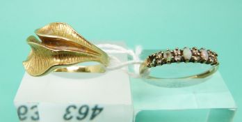 A yellow metal textured ring marked 18k (5.1g) and a 9ct gold ring set with opals (1.