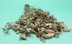 Three silver charm bracelets with silver and white metal charms including a pheasant, fox, pig,