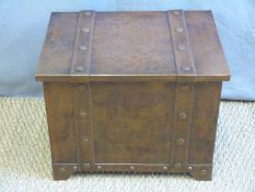 An Arts and Crafts style coal box with loop handles and inner liner,