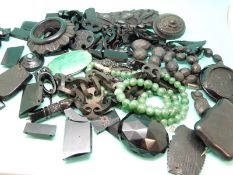 A quantity of jet jewellery, including, brooches, beads, carved pieces etc and a jadeite necklace.