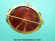 A large yellow metal brooch set with faux agate