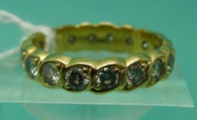 An 18ct gold eternity ring set with round brilliant cut diamonds, each measuring approximately 0.