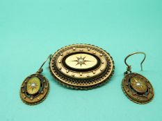 A Victorian yellow metal mourning brooch set with a pearl to the centre in a star setting with