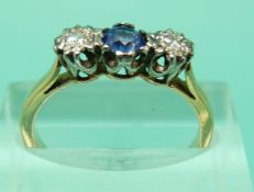 An 18ct gold ring set with a sapphire and diamonds