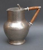 A Tudric pewter hammered jug, height 18.