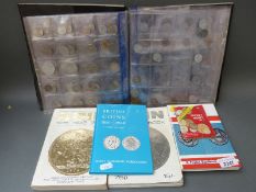 A collector's album of world coins together with a quantity of collector's books