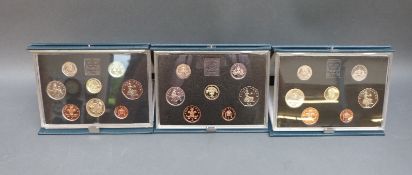 Three deluxe cased Royal Mint proof coin sets 1986,