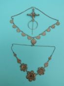 A white metal filigree necklace made up of three layered flowers,