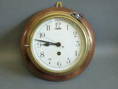 A brass cased marine/ships clock the Arabic dial with spade hands and seconds sweep,