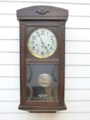 An oak cased wall clock with three train movement,