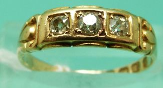 An 18ct gold ring set with three diamonds,