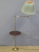 A brass library lamp with tray table and articulated arm,