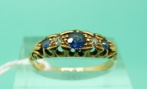 An 18ct gold ring set with alternating sapphires and diamonds,
