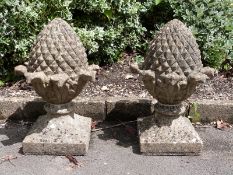 A pair of carved stone pineapple or pine cone finials,