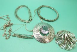 A hallmarked silver Scottish brooch set with an amethyst, a silver bangle,