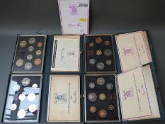 Four deluxe cased Royal Mint coin sets for 1983, 1984,