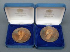 Two commemorative Tutankhamun cased medallions - silver gilt,