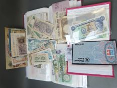 Approximately 150 world bank notes in three albums, some loose,
