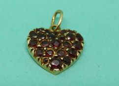 A 15ct gold heart pendant set with garnets