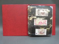Approximately 100 uncirculated overseas banknotes in a collector's album, includes Nicaragua,