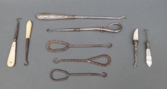 A quantity of button hooks including a hallmarked silver handled example