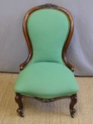 A 19thC mahogany spoon back chair with serpentine front raised on carved legs and brass castors