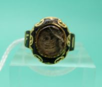 An 18ct gold mourning ring, London 1875, set with black enamel,