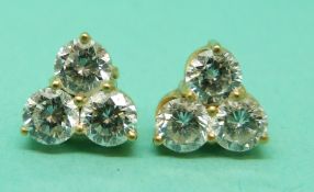 Kutchinsky pair of 18ct gold earrings, each set with three round brilliant cut diamonds,