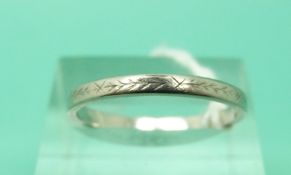 A platinum wedding band with cross decoration (Size Q)