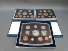 Three deluxe cased Royal Mint proof coin sets 1998, 1999 and the 2000 Millennium example,