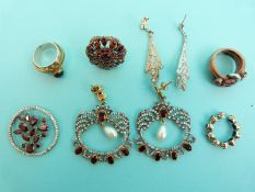 A silver ring set with garnets, a pair of silver earrings set with garnets and paste,