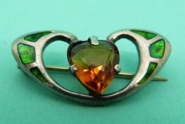 A hallmarked silver Charles Horner brooch set with green enamel and a heart cut citrine.