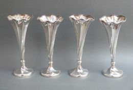 A set of four Victorian Art Nouveau hallmarked silver spill vases of wrythen design,