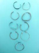 A quantity of silver bangles,