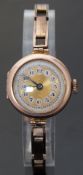A Swiss made yellow metal ladies wristwatch with engine turned face,