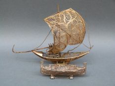 A Maltese silver filigree rowing boat, marked 800, 10cm long, 28.
