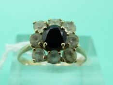 A 15ct gold ring set with a round cut sapphire surrounded by paste in a square setting (Size O)