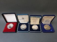 Four crown sized cased coins includes silver