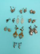 Ten pairs of white metal filigree earrings including one in the form of shoes,